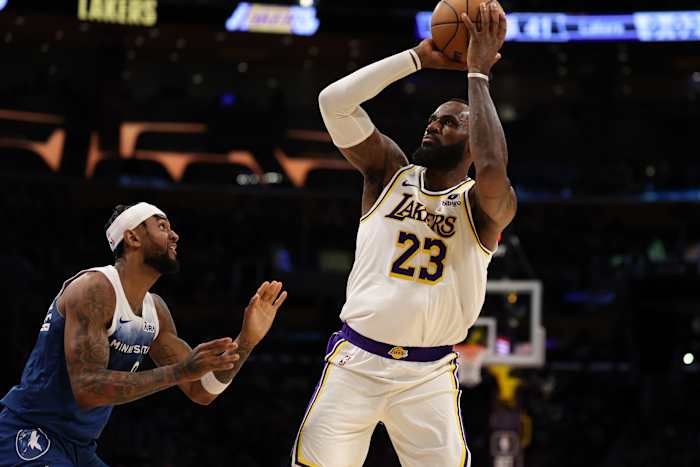 Mar 10, 2024; Los Angeles, California, USA; Los Angeles Lakers forward LeBron James (23) shoots the ball over Minnesota Timberwolves guard Nickeil Alexander-Walker (9) during the second quarter at Crypto.com Arena.